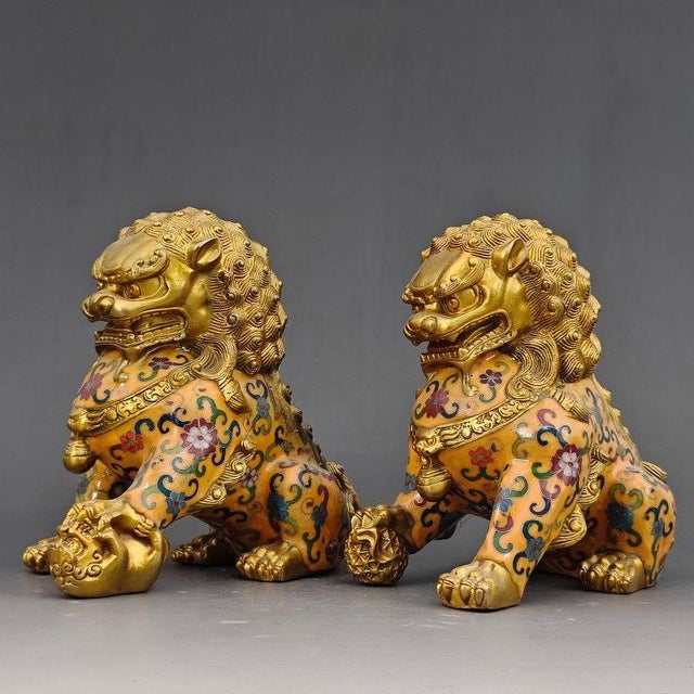This is a matching pair of vintage guardian lion (often referred to as Foo Dog) statues, crafted from copper with...