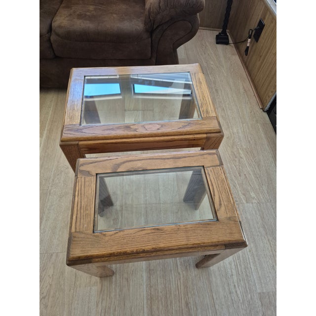 Featuring a pair of vintage 1970s/80s Parsons-style end tables crafted from solid oak with inset glass tops. These tables...
