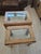 Featuring a pair of vintage 1970s/80s Parsons-style end tables crafted from solid oak with inset glass tops. These tables...