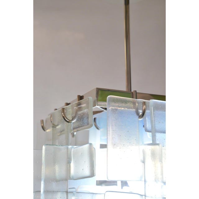 One-of-a-kind, hand-made fixtures by master glass artist, Moshe Bursuker. Each "strand" of fused, C-shaped, clear and...