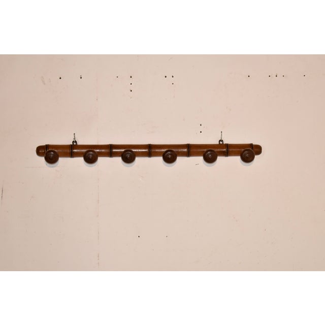 Circa 1920's hand turned cherry hat or coat rack from France. The back of the rack is hand turned to give the appearance...