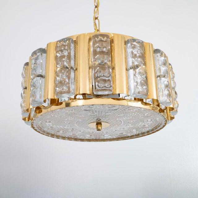 Brass and molded glass pendant by Carl Fagerlund for Orrefors.