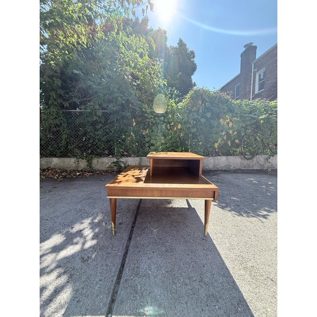 A classic vintage side table by Lane Furniture, featuring the clean lines, warm wood tones, and thoughtful construction...