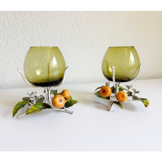 A wonderful pair of mid-20th-century vintage Italian Toleware hurricane candle holders or vases. These feature whimsical,...