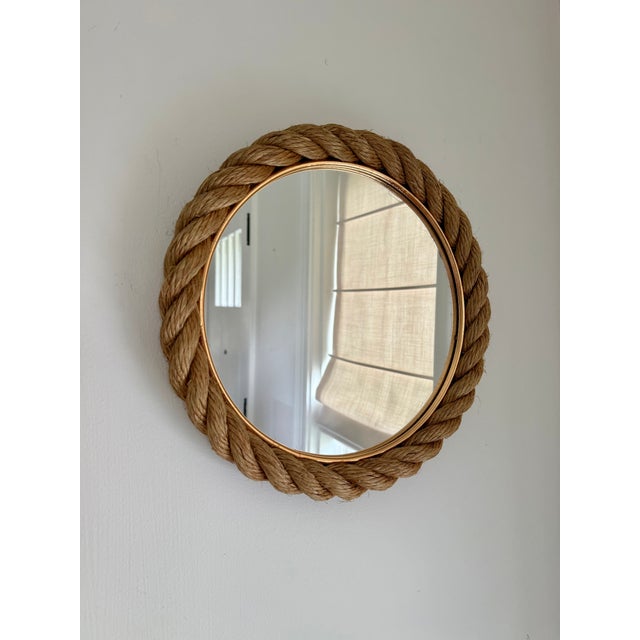 1960s Audoux Minet round wall mirror with twisted rope and a gilt brass inner ring. Mirror glass is clean, minor fraying...