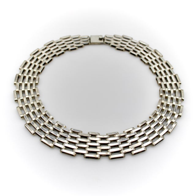 This is a very intricate, completely handmade Taxco sterling silver collar necklace with wide links and a beautiful...