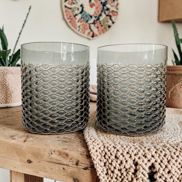 Elevate your home decor with our Smokey Transparent Chicken Wire Bubble Glass Pillar Candle Holders/Vases. Crafted from...