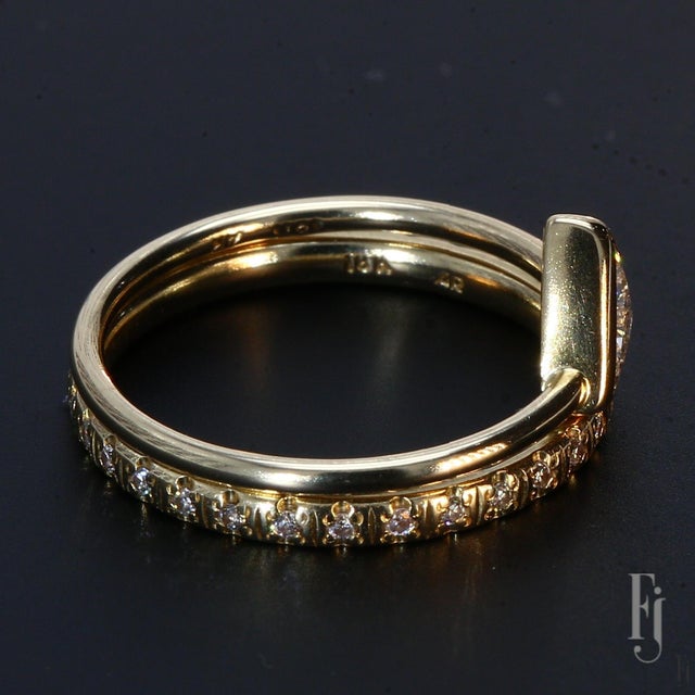 Here is a set of 18k Yellow Gold Stackable Rings with One ~0.3ct. E/VS2 Trillion Cut White Diamond Center & Round Accent...