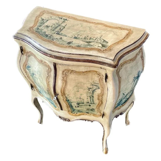 Antique hand-painted Venetian bombe commode with two doors and a key. Hand-painted Venetian scenes on sides, doors, and...