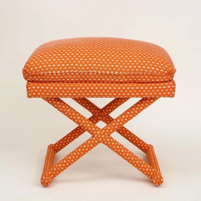 Made by DeAngelis for Mario Buatta; with rectangular fixed cushion over the X-form frame, all upholstered in a salmon pink...