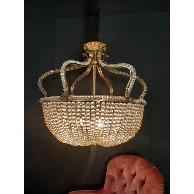 Large Parisian chandelier made of fire-gilded bronze in the shape of a royal crown, rich pearl hangings, 4 focal points...