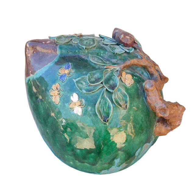 This is a decorative Chinese ceramic pottery peach shape display in Oriental green and turquoise. There are relief motif...