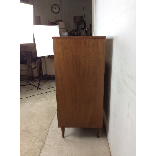 This mid century modern four drawer highboy dresser features hardwood construction, walnut veneer with original finish,...