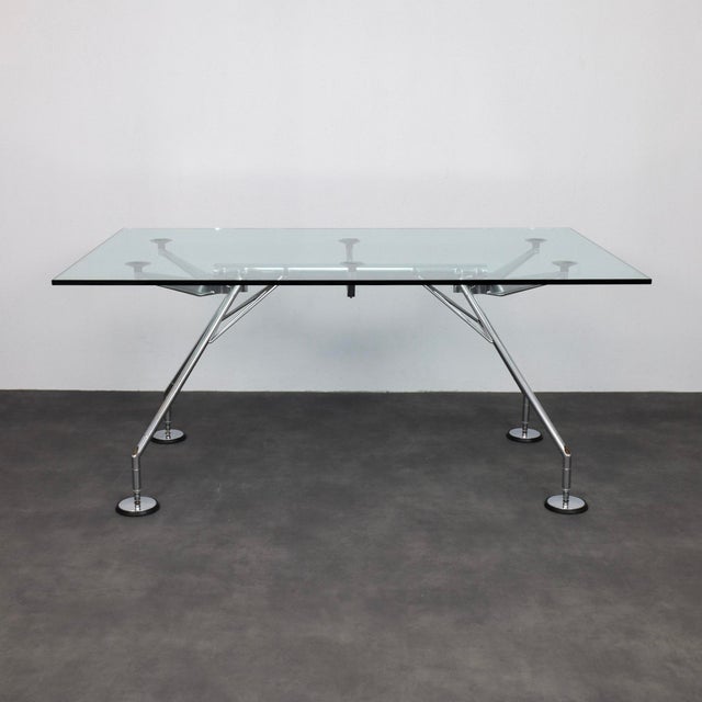 The nomos table, designed by norman foster in 1987, is a precise study in structural clarity and architectural logic....