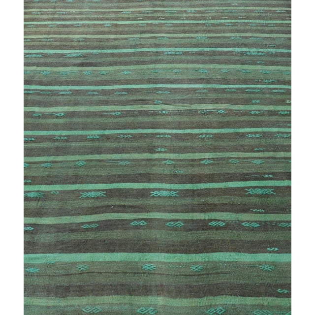 Measures: 7'1 x 10'2 This vintage Turkish kilim rug features a harmonious blend of earthy tones and vibrant turquoise. The...