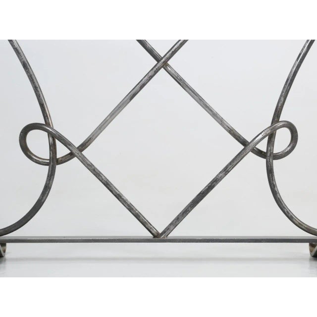 A scrolling fireplace screen hand-made in Chicago, in a style between French 40's to midcentury modern. The depth show is...