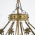 An antique French style chandelier offers brass frame in Fleur-de-Lis form having twelve floral form arms terminating in...