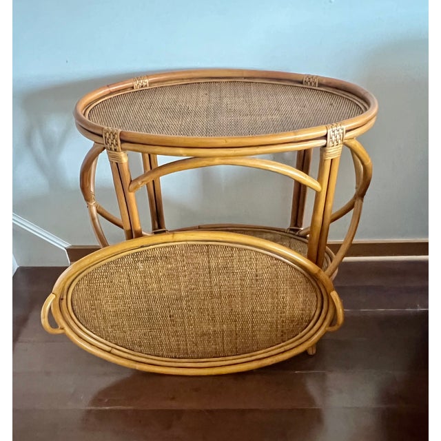 A beautifully crafted vintage bentwood rattan serving table in the style of McGuire, featuring a removable tray top and...