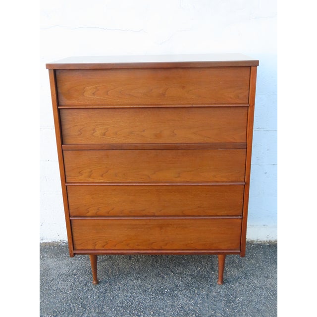 This magnificent Chest of Drawers is made of wood, and veneer. This wonderful piece is an excellent example of the Mid...