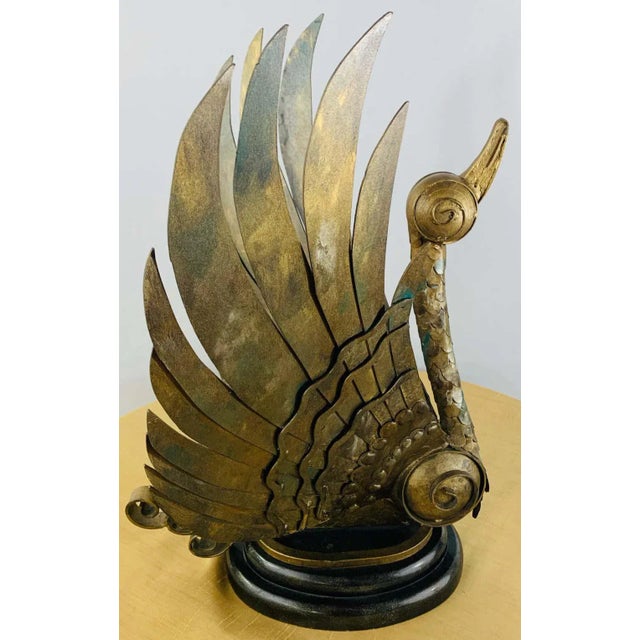 A unique and highly decorative pair of Brutalist style swan statues in bronze both in a takeoff position. The wings are...