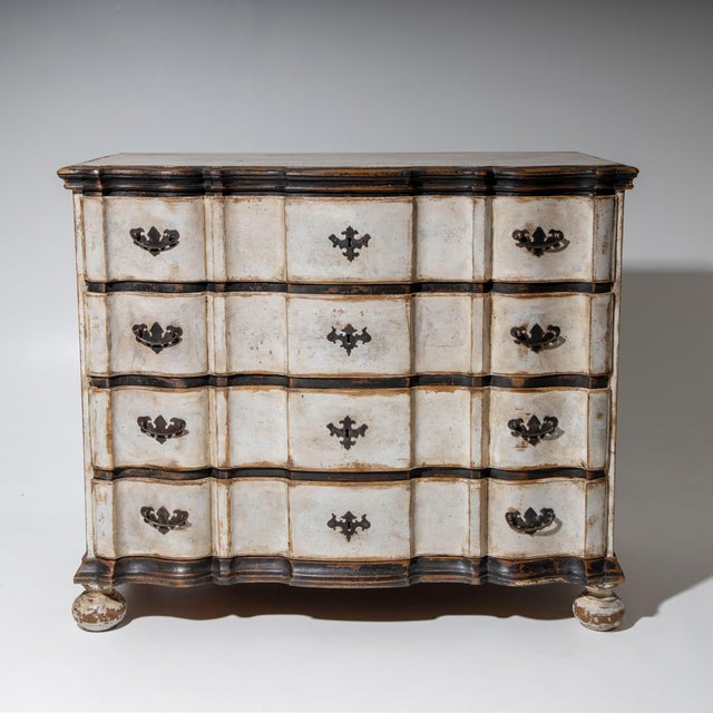 Large Baroque chest of drawers painted in white with anthracite accents and prominent brass fittings. Featuring chamfered...