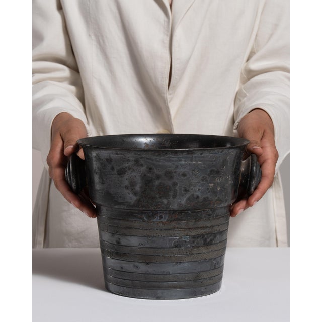 This mid 20th century ice bucket from France is finished in gray, worked in silver. Its form follows honest, well-...