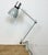 Industrial table lamp made by Elektrosvit in former Czechoslovakia during the 1970s. It features an iron base, an iron arm...