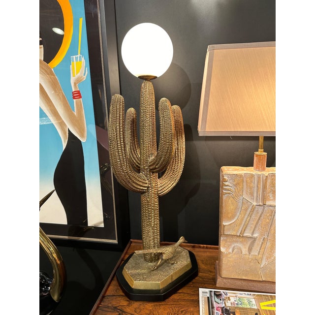 Brass saguaro cactus and roadrunner sculpture from 1970’s mounted as lamps. Only brass cactus is 29" high. Globe shade is...