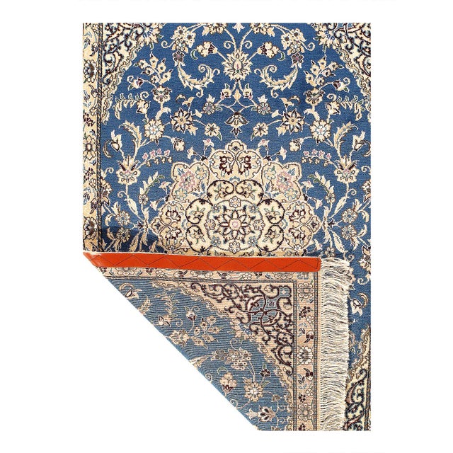 Persian Nain rugs are renowned for their detail and fine use of outlining along the central motifs. Breaking from the...