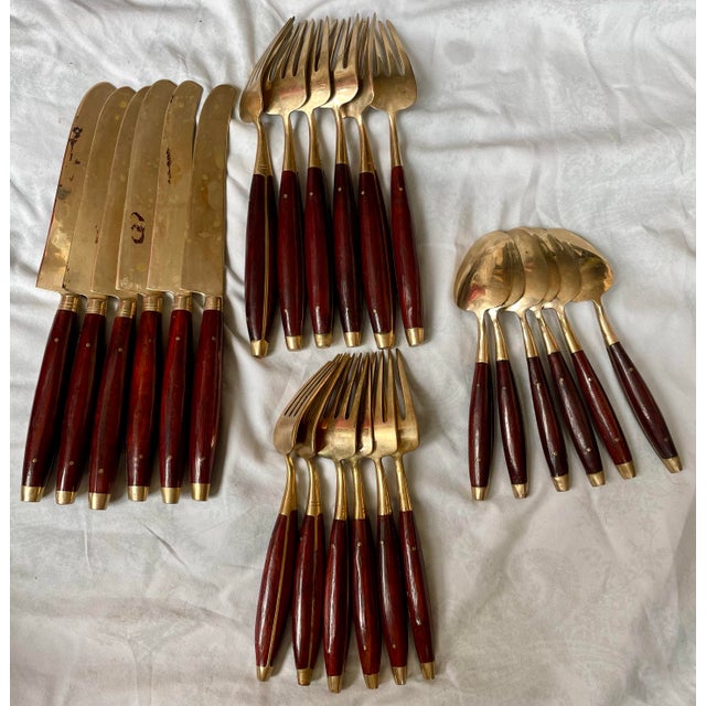 Here is an elegant set of 24 pieces, a service for 6 - knives, forks and spoons, made of beautiful brass and rose wood...