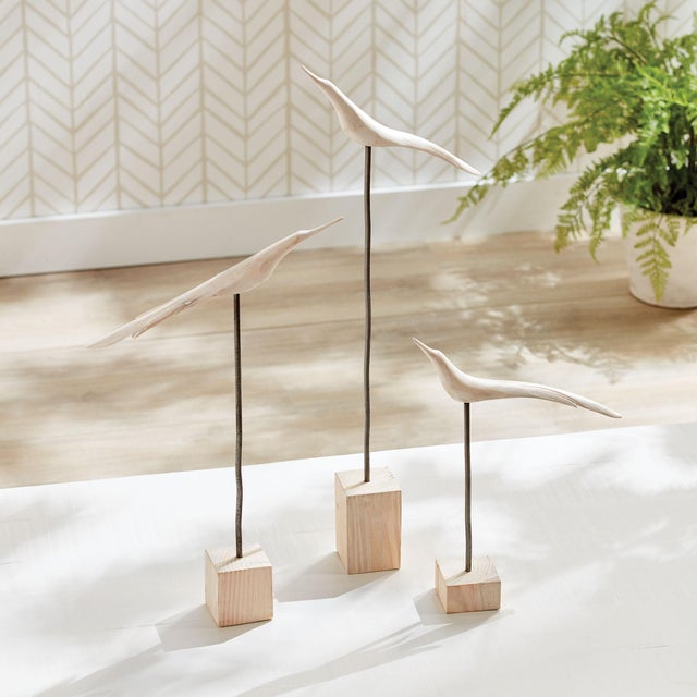 A modern, abstract rendition of birds sits atop basic wood pedestals. A handcrafted rustic set that is worthy of study,...