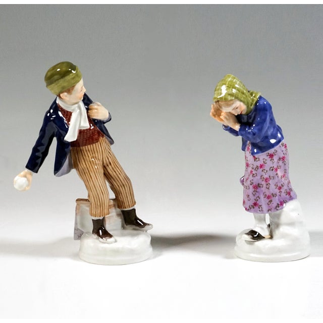 Very charming meissen art nouveau porcelain figurines: boy in dark blue jacket, under it a brown vest, striped pants and...