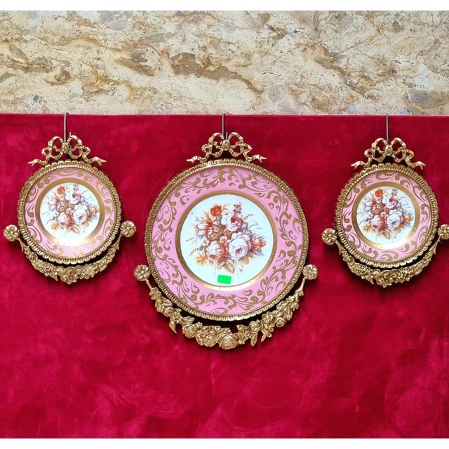 This elegant set of three Baroque-inspired wall art pieces features delicate floral artwork surrounded by beautiful pink,...