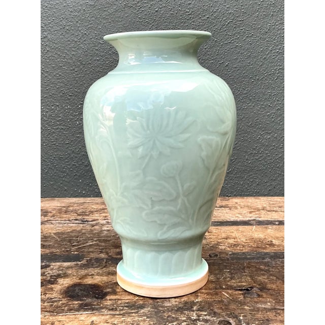 This vintage celadon ceramic vase brings a serene pale-green presence to a room through its lustrous glaze and finely...