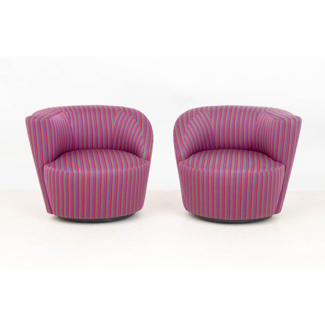 Pair of Vladimir Kagan Nautilus Style Swivel Lounge Chairs, in multi-colored striped upholstery. 28" H x 31" W x 34" D;...