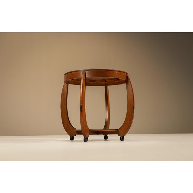 This sculptural Dutch side table was produced in the Netherlands during the 1920s and is associated with the expressive...