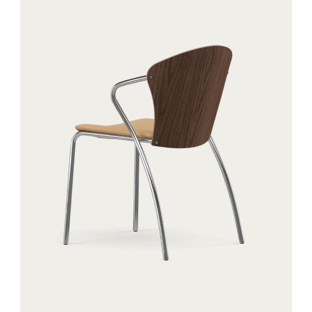 Erla solveig oskarsdóttir bessi chair frame: black, wood types: walnut , upholstery: sand for one collection designed in...