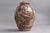 Lidded jug by Jais Nielsen (1885–1969) for Royal Copenhagen. Sun-glazed stoneware lidded jug/urn with relief decoration...