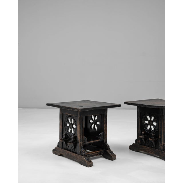 This pair of 20th Century French black-patinated wooden stools features a distinctive architectural presence, combining...
