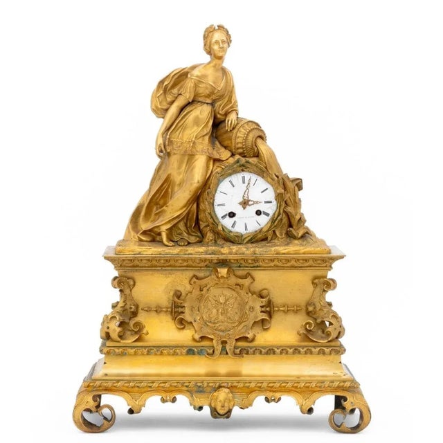 French Empire Gilt Bronze Figural Clock, circa 1830, the white enamel dial and movement strik on bell surmounted by a...