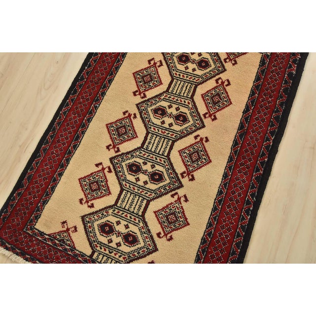 An authentic vintage tribal Baloch rug hand-knotted with fine wool and natural dyes. This nomadic oriental rug features a...