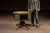 Octagonal revolving séance or spirit table featuring a richly toned wood frame and a worn green leather writing surface...
