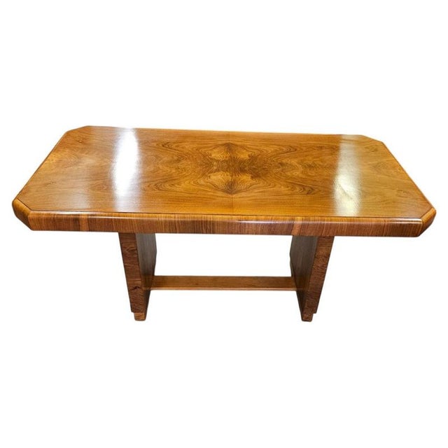 A handsome British Art Deco dining table dating to circa 1930, beautifully crafted in richly figured walnut and...