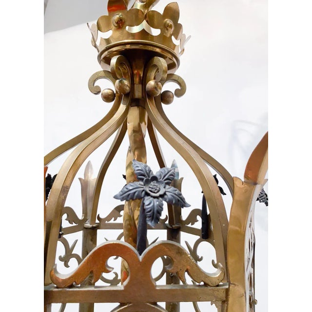 Brass lantern with hand forget black flowers. It has been rewired and it has 3 candelabra base sockets that each can hold...