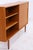 Vintage highboard from WK Möbel with clean lines and warm teak grain. The large sliding door can be moved from either...