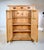 An Antique Vertigo pine cabinet featuring a single long drawer above a two-door cupboard cabinet with three removable...