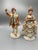Pair of vintage Italian-style porcelain courting figurines featuring an elegantly dressed lady and gentleman in 18th-...
