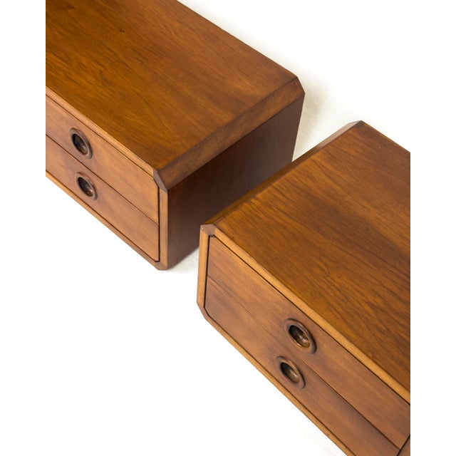 A refined pair of Danish mid-century floating wall-hung nightstands with two drawers each and an open side compartment....