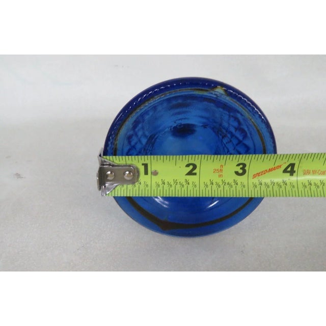 This lovely perfume bottle is made of glass. This bottle is marked as being made by Avon in 1976, see pictures, and it...