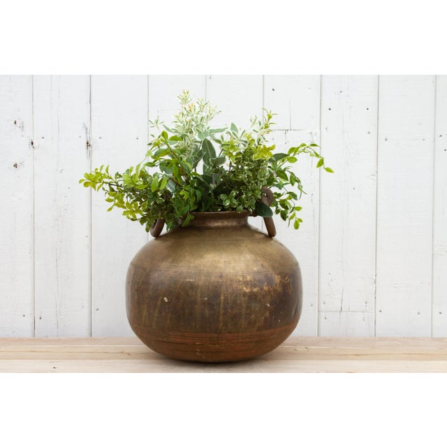 This gorgeous antique Indian brass planter with handles is a perfect addition to any space, combining a unique antique...